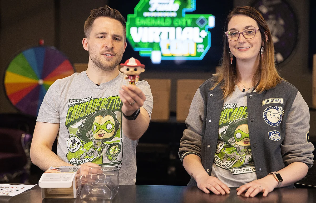 Cameron Deuel and Hilary Gray of Funko display the ECCC exclusive Fireman PEZ Pal Funko Pop! during the first ever Funko Emerald City Virtual Con at Funko HQ | Getty Editorial Use
