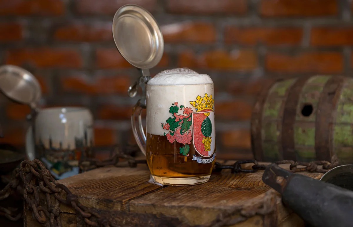 Traditional German beer stein with a silver lid