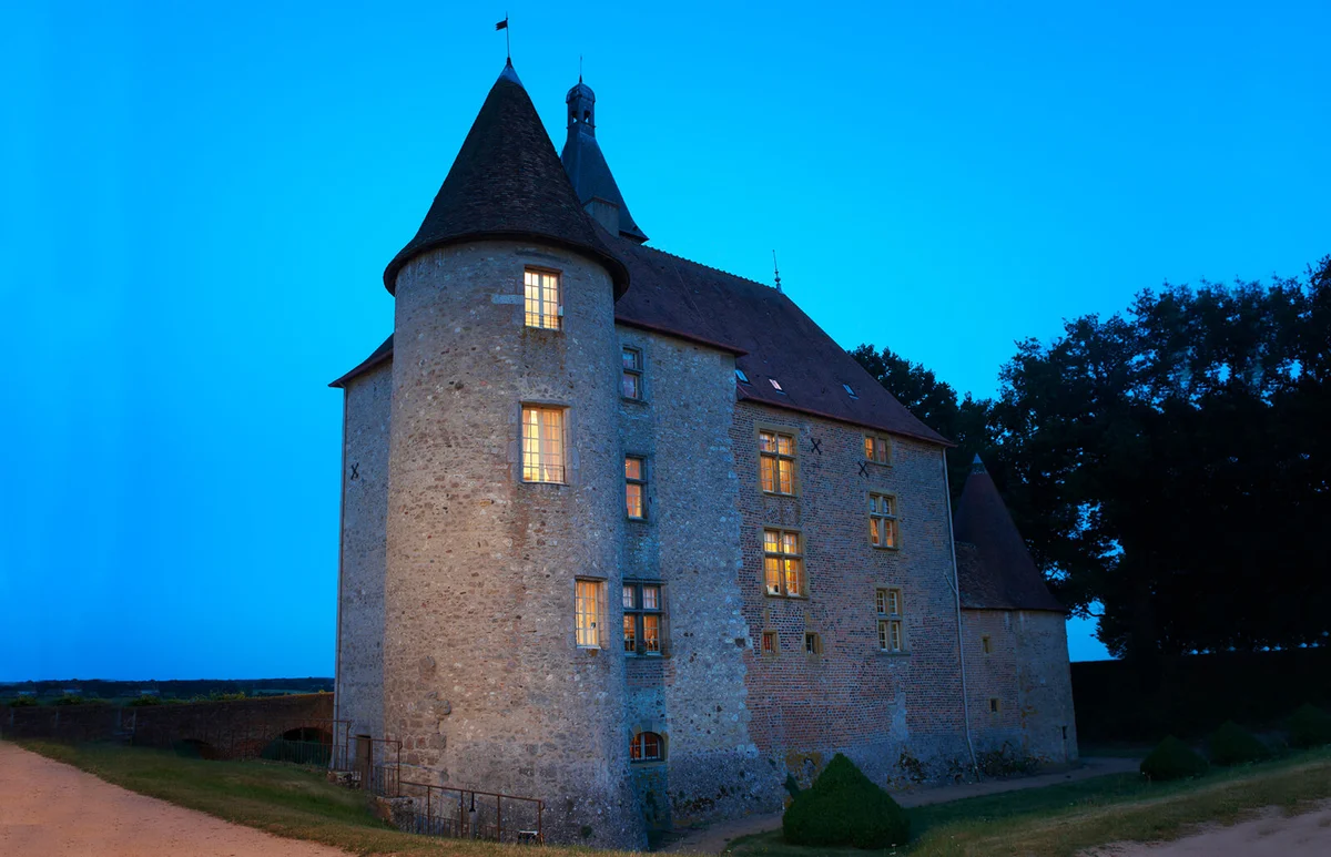 Stone house lit up at night