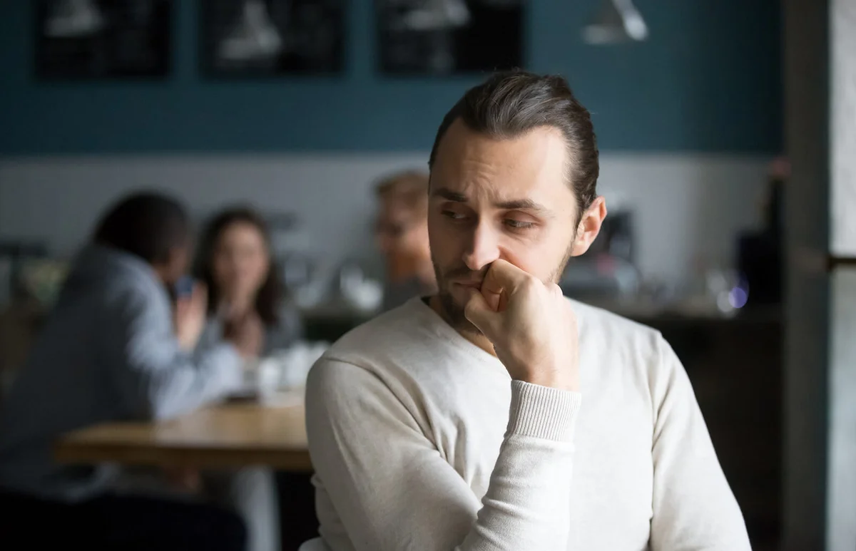 Upset male outcast feel lonely sitting alone in cafe