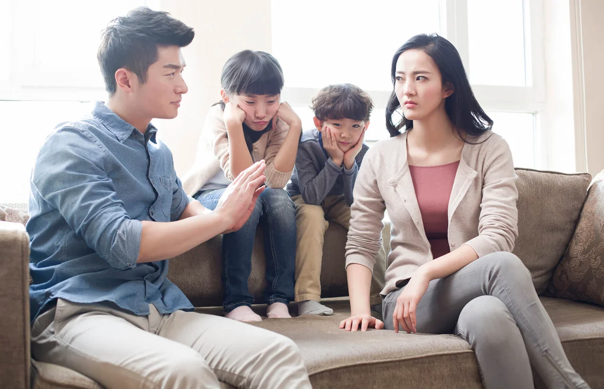 Two children listening to their parents arguing