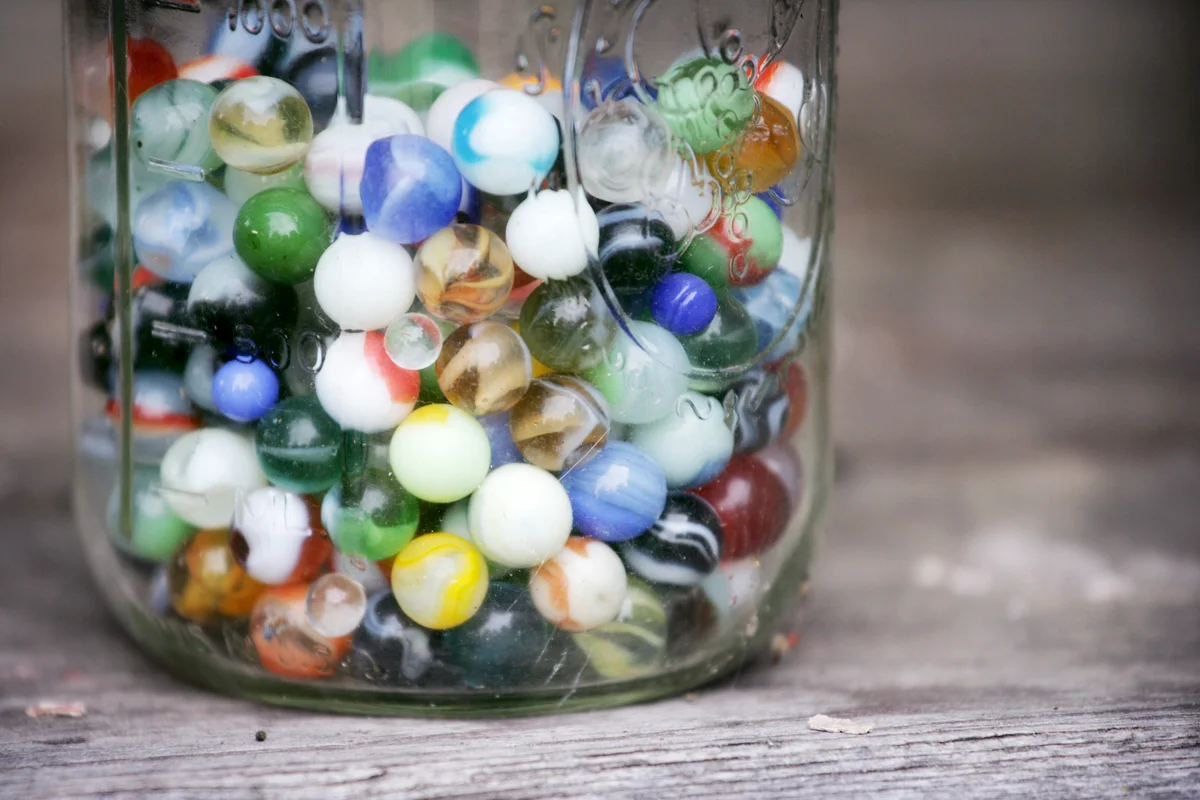 Old Colorful Marbles in a Glass Jar