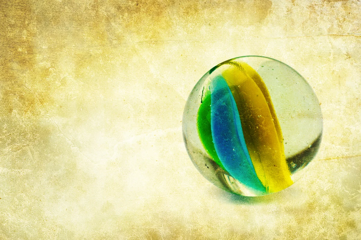 Glass marble on textured background