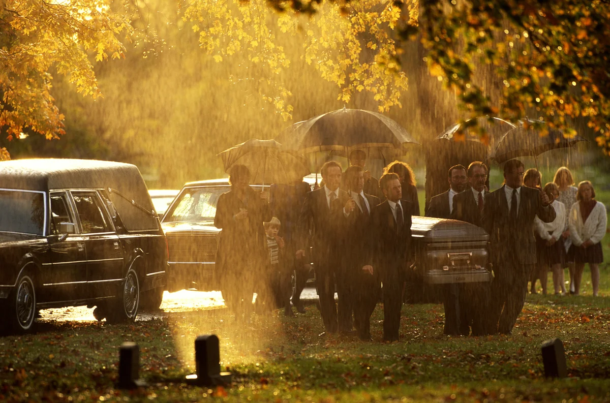 Funeral procession in the rain