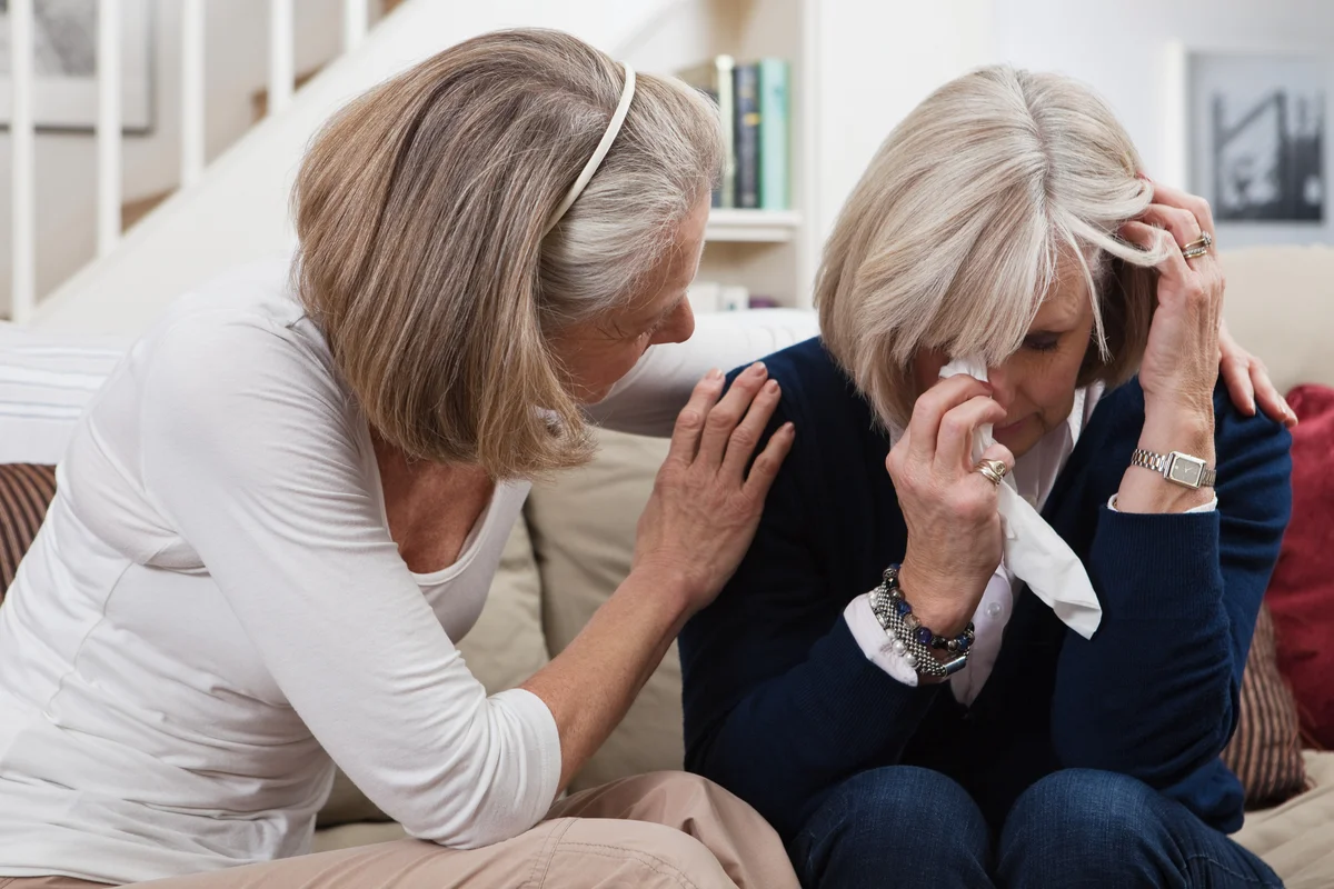 Woman consoling grieving friend.