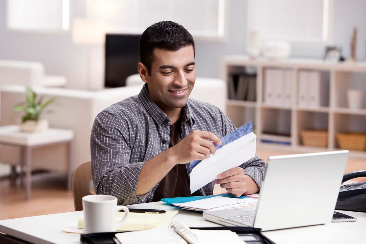 Man reading thank you note at the office