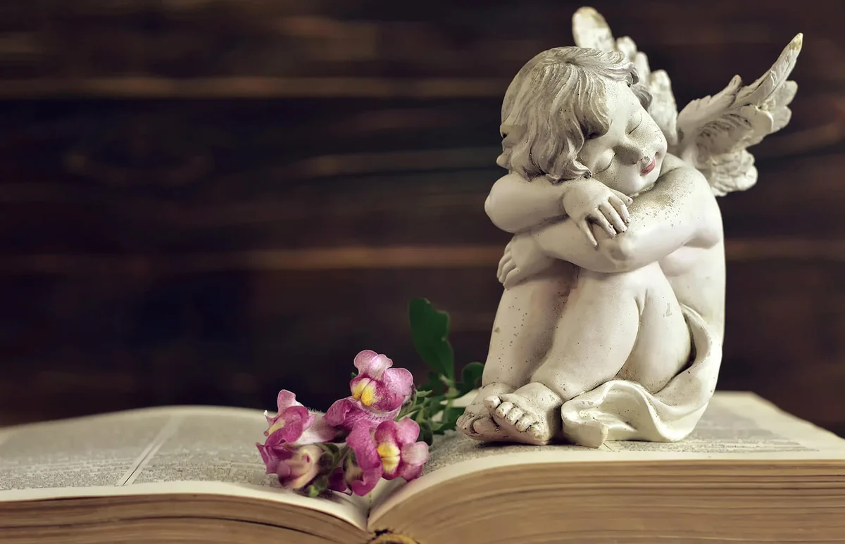 Guardian angel and dragon flowers on old book