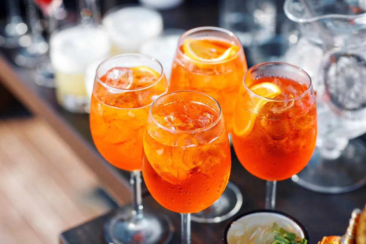 Spritz cocktail in misted glass with orange