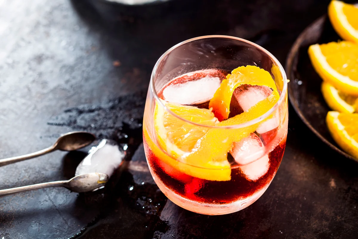 Old fashion with orange peel and ice cubes
