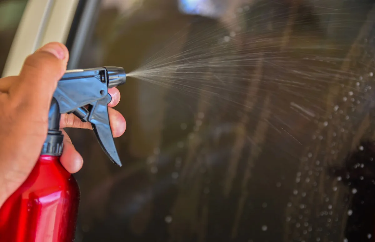 Spraying WD 40 on car