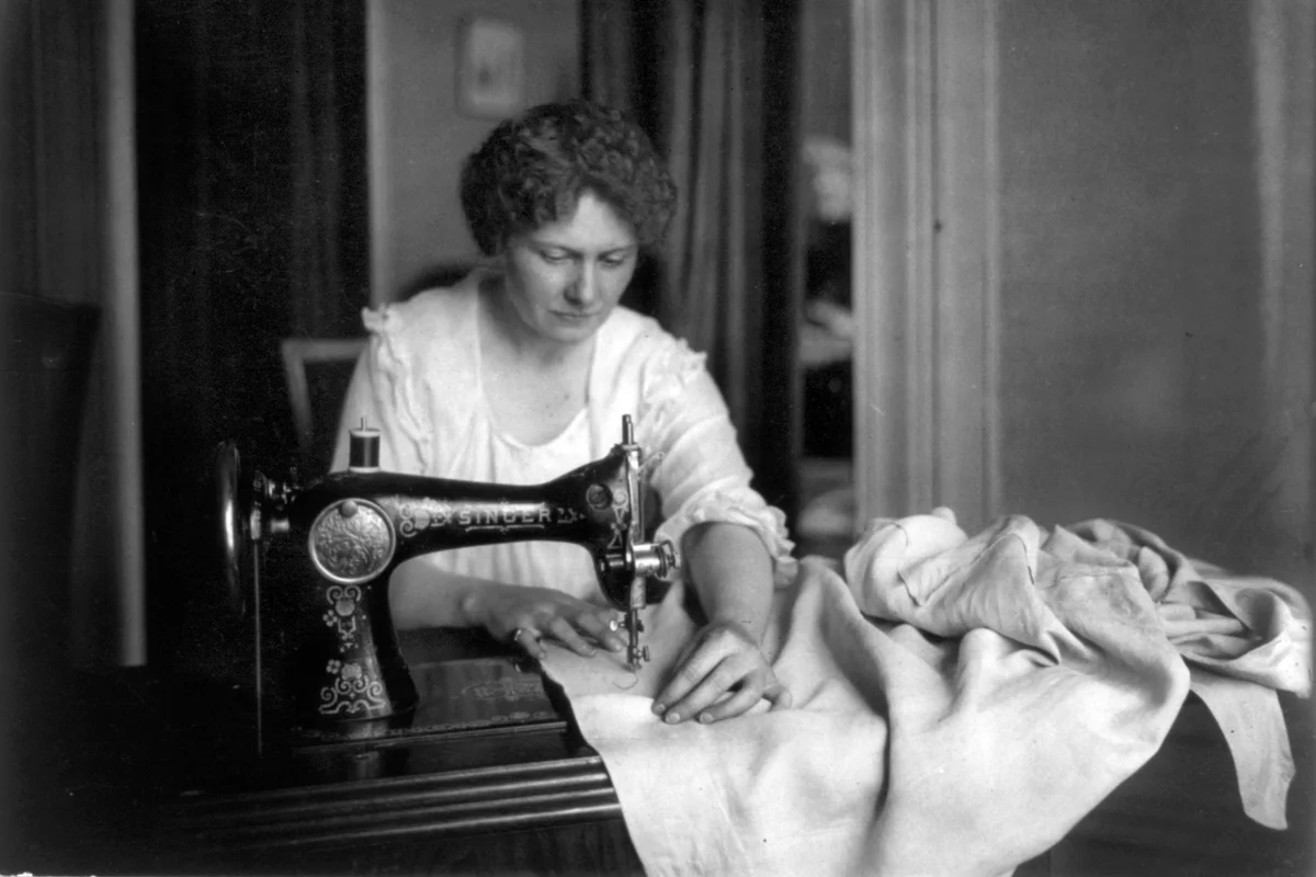 Woman sewing with a Singer sewing machine