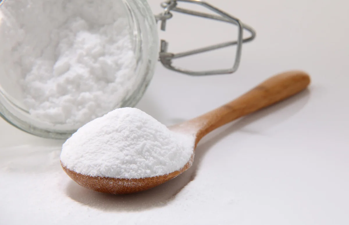 Baking soda in wooden spoon