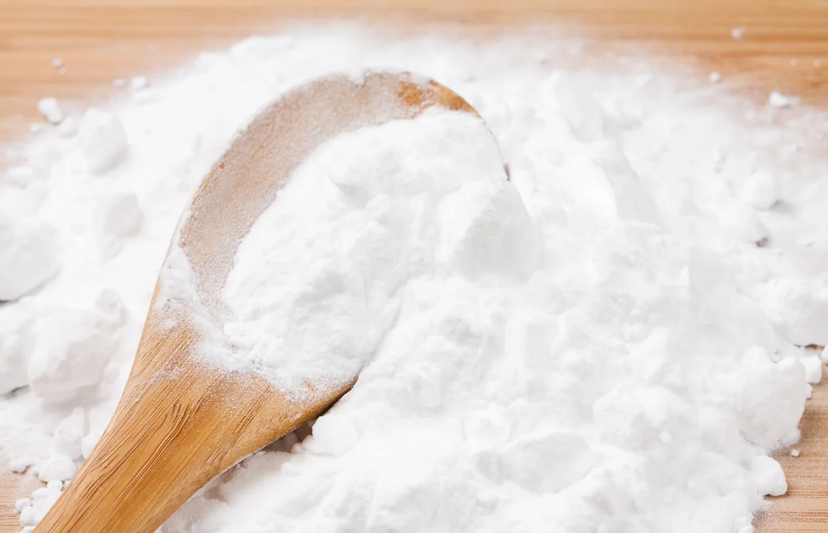 Baking soda with wooden spoon