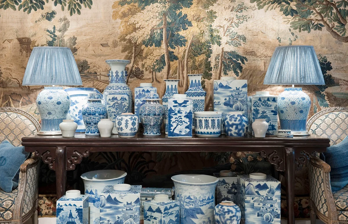 collection of Chinese blue and white porcelain planters and baluster vases on console table with tapestry back drop Guinevere's antique shop on Kings Road, Chelsea, London, UK