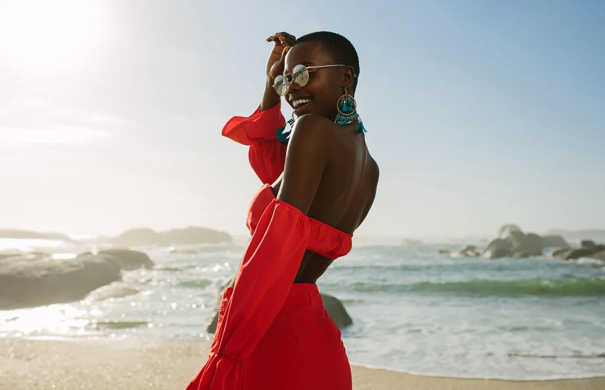 woman in red dress enjoying the beach