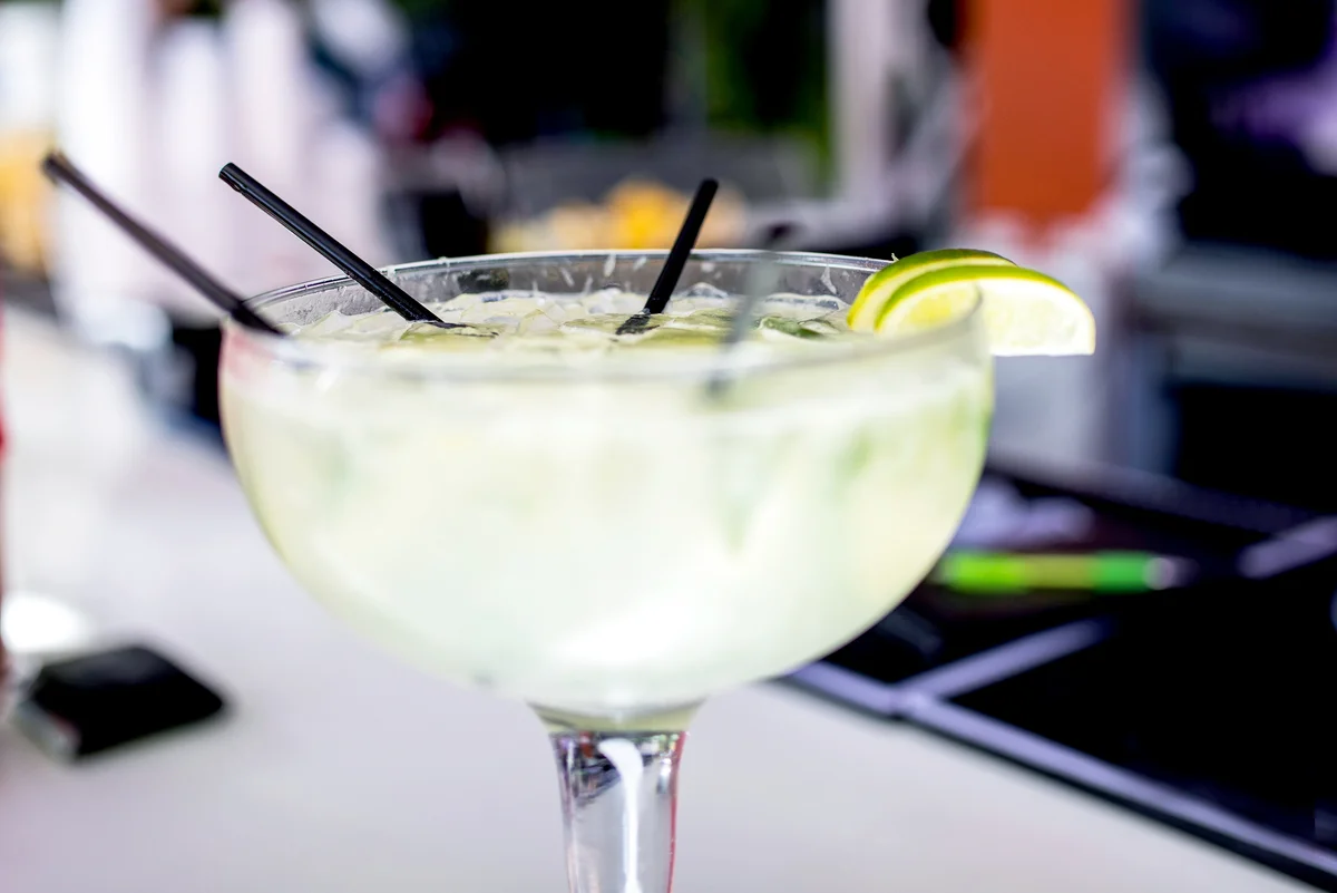 White cocktail with lime and coconut
