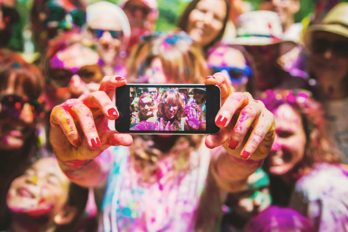 Group of friends taking a selfie together during a Holi celebration party