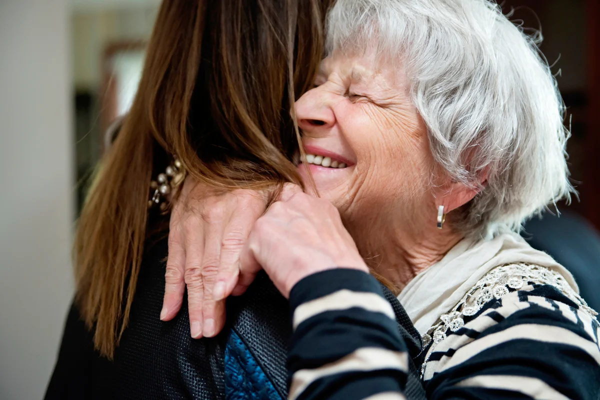 Grand-mother and adult grand-daughter hugging