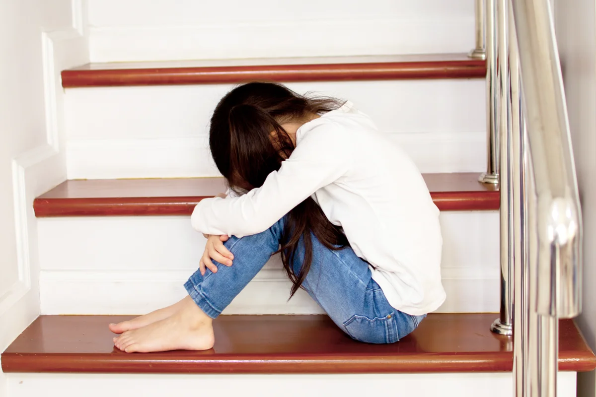 Child crying on the staircase