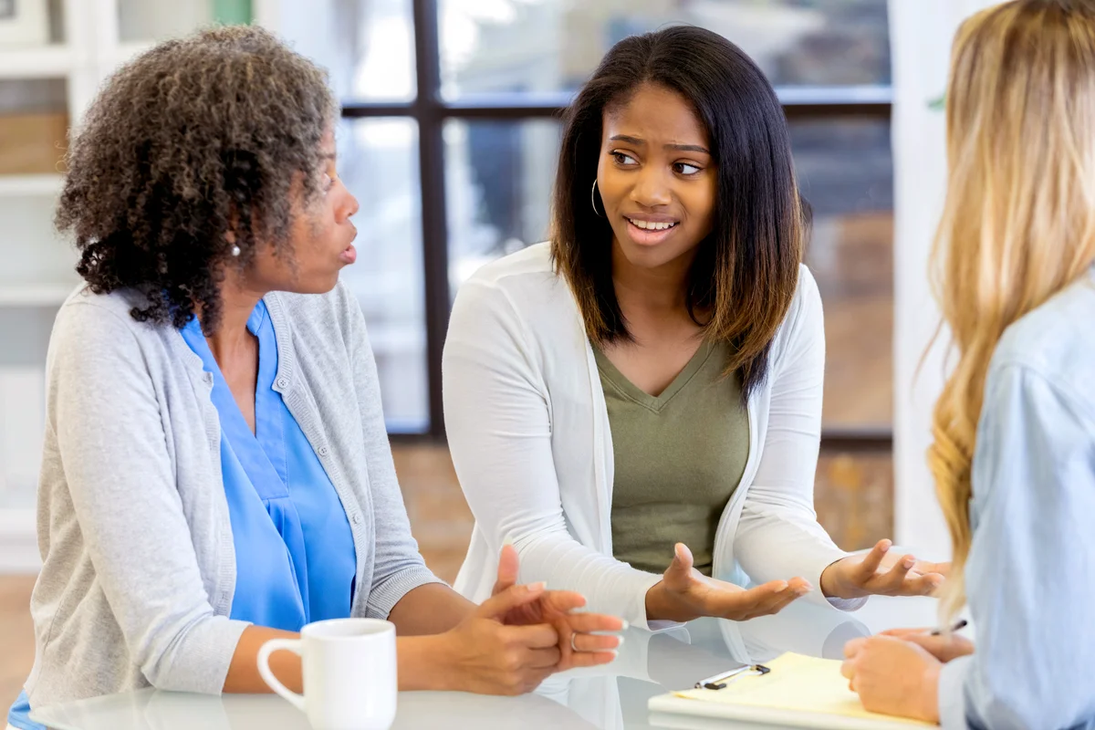 Teenage girl and her mom talk during counseling session