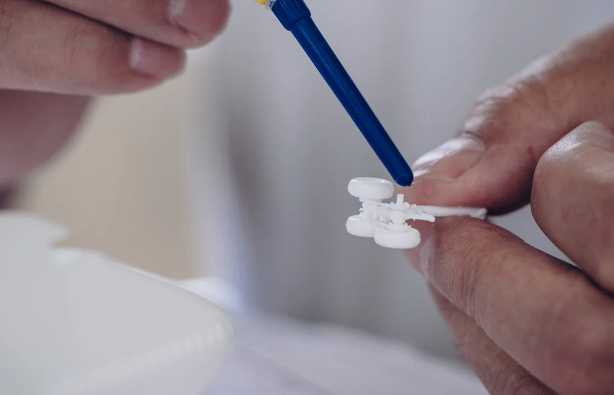 Senior Man using super glue on plastic