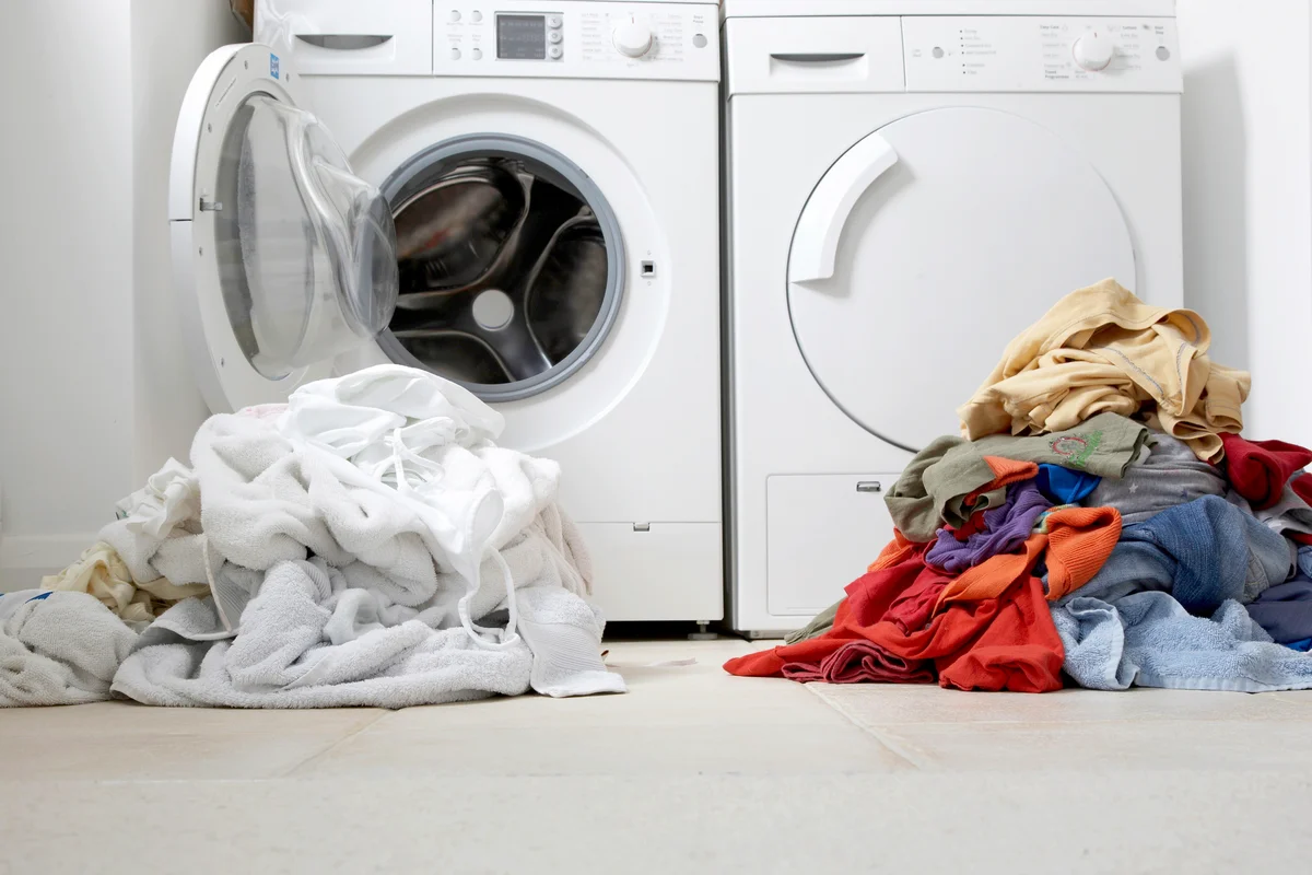 One coloured pile of clothes and another one of white clothes for washing