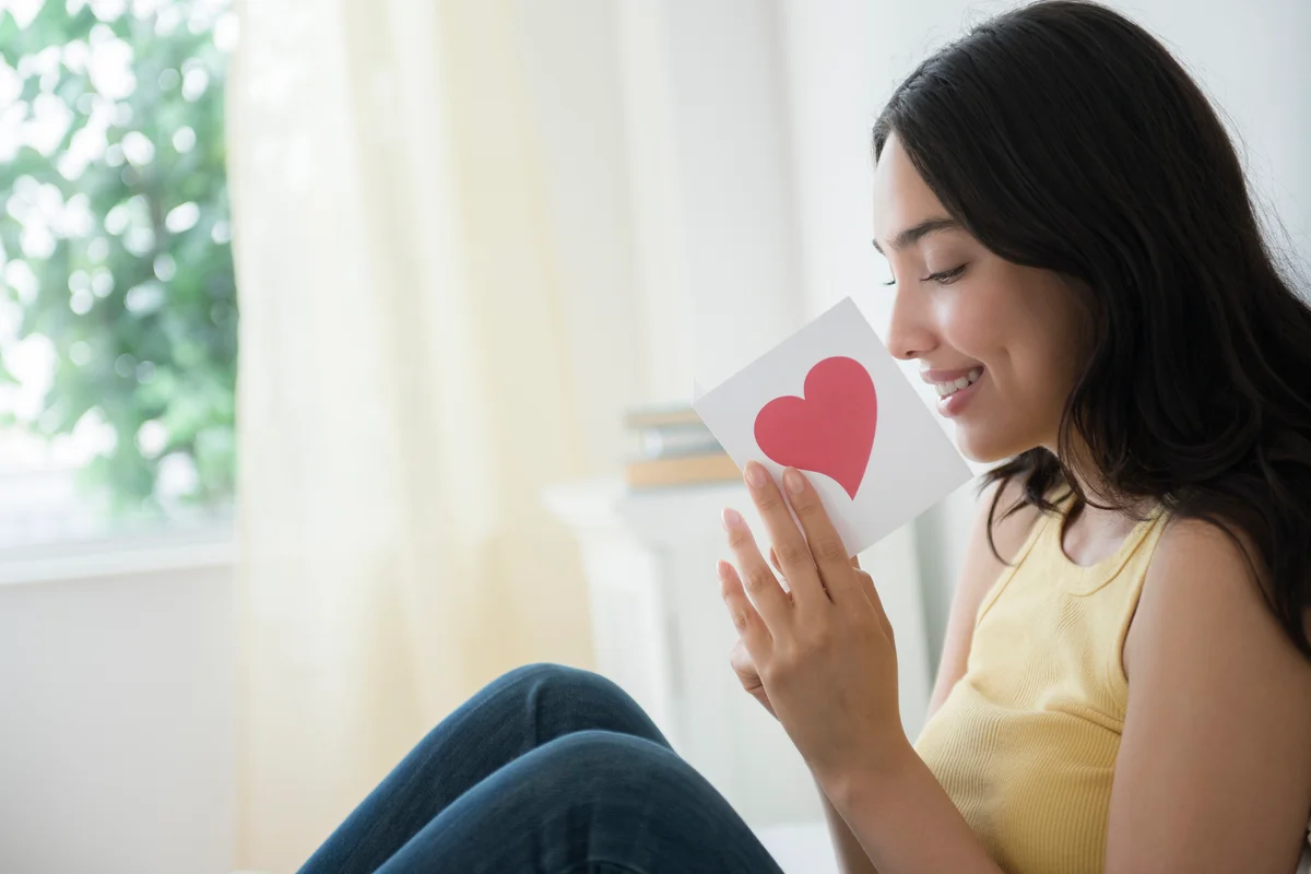 Woman reading romantic card
