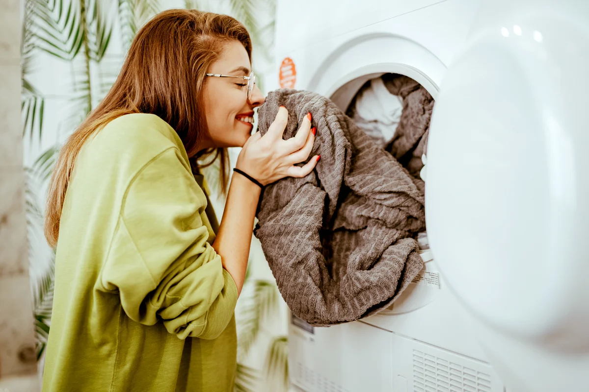 Young woman doing her laundry at home