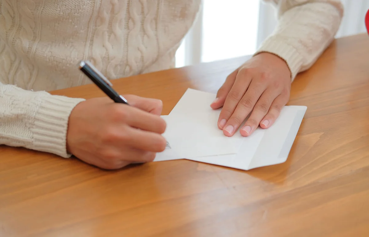 man writing sympathy card