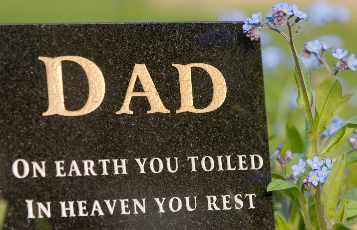 black granite memorial plaque with inscription to a dead father