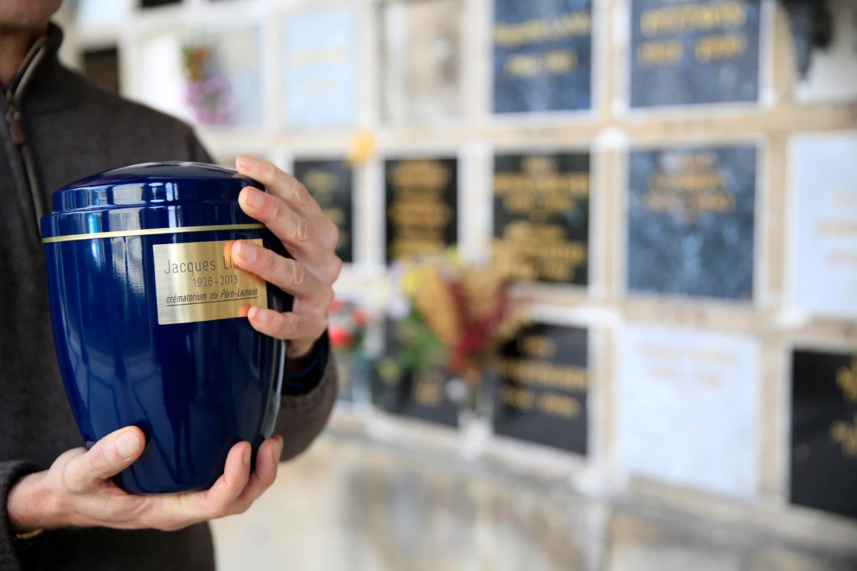 Man holding a cremation urn