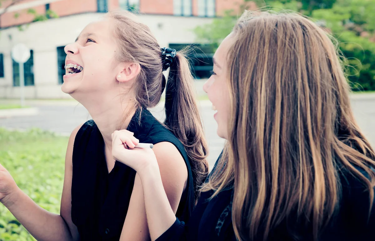 Teenagers laughing at a funeral