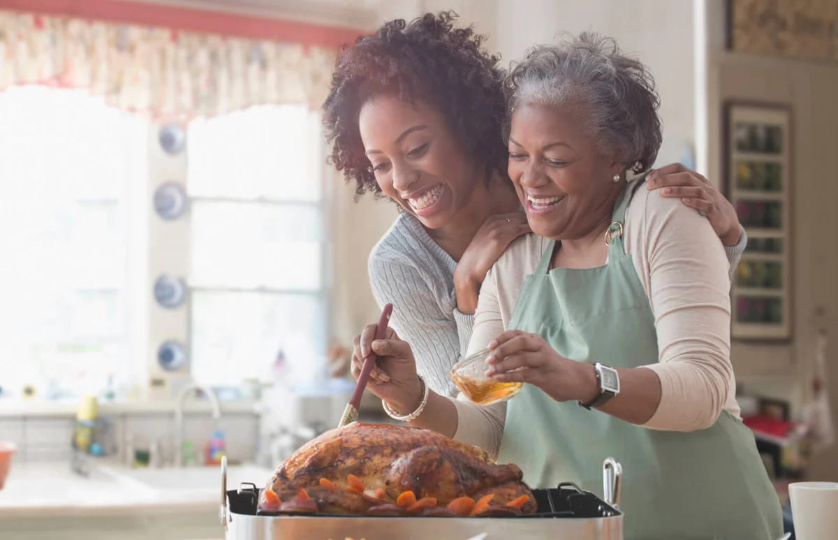 Mother and daughter cooking together in the kitchen
