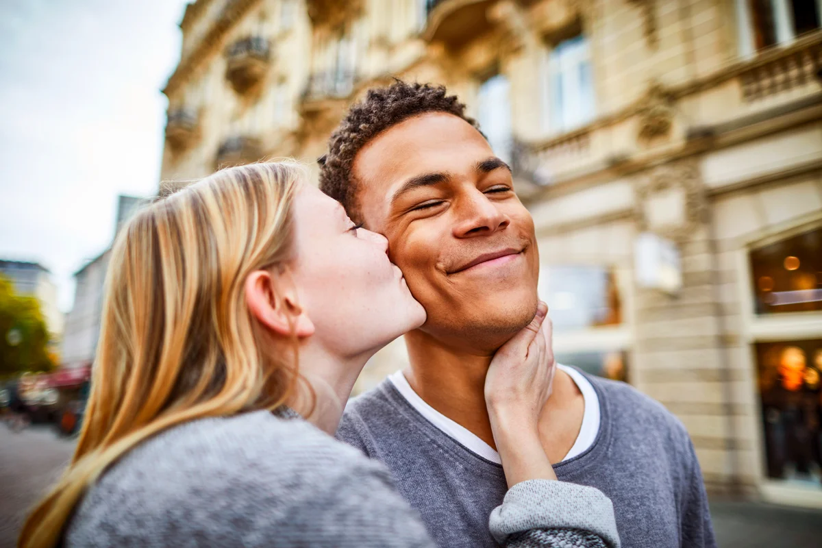 Young woman kissing boyfriend in the city