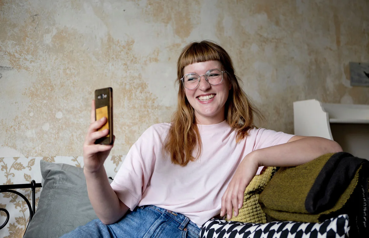 Woman taking a selfie at home