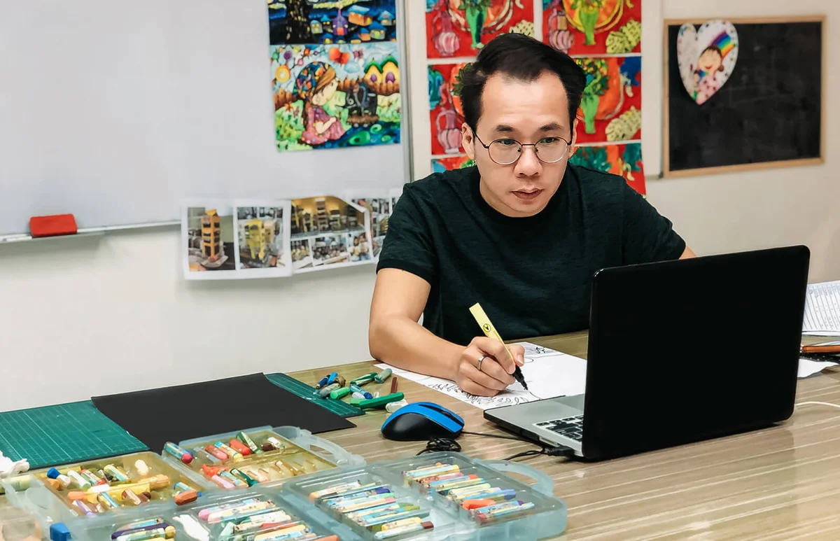 male teacher teaching online class at art school