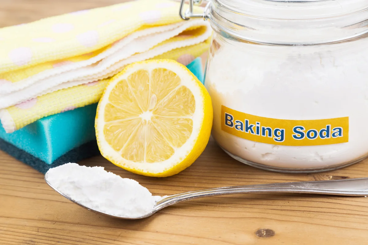 Baking soda, lemon, sponge and towel for cleaning