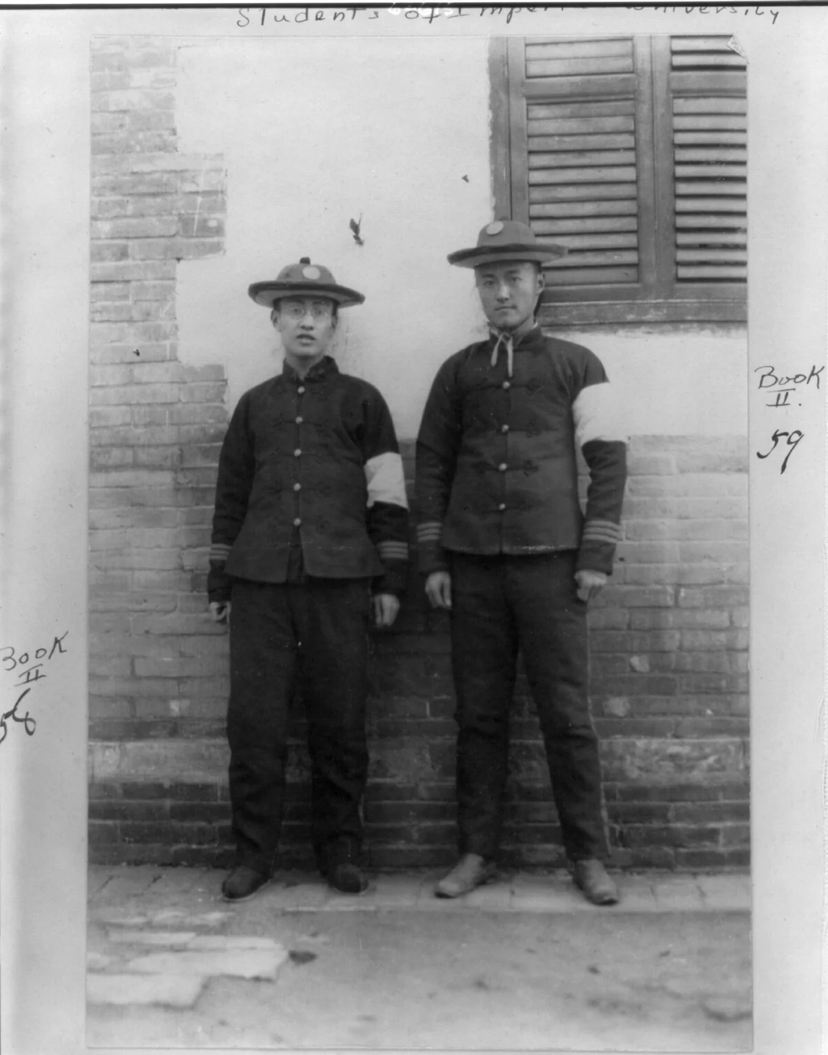 Two Imperial University students wearing white armbands on left arm of military uniform