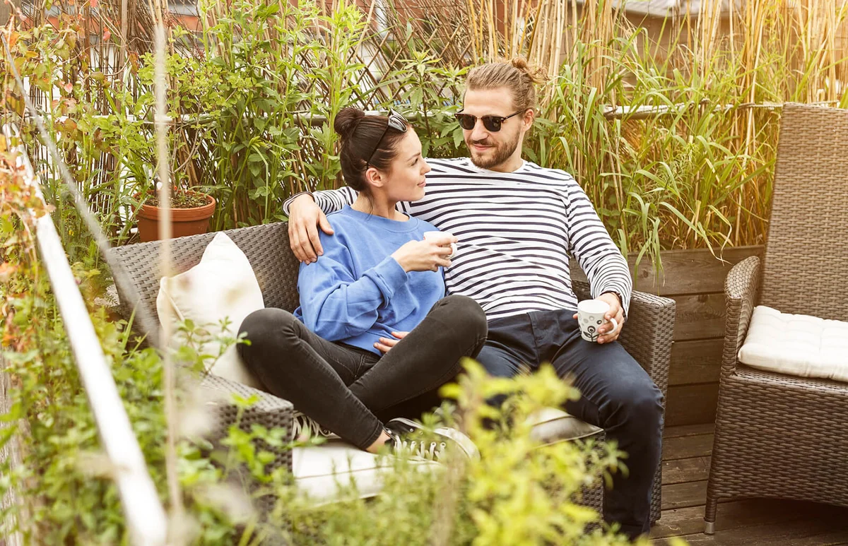 Young couple relaxing on their balcony