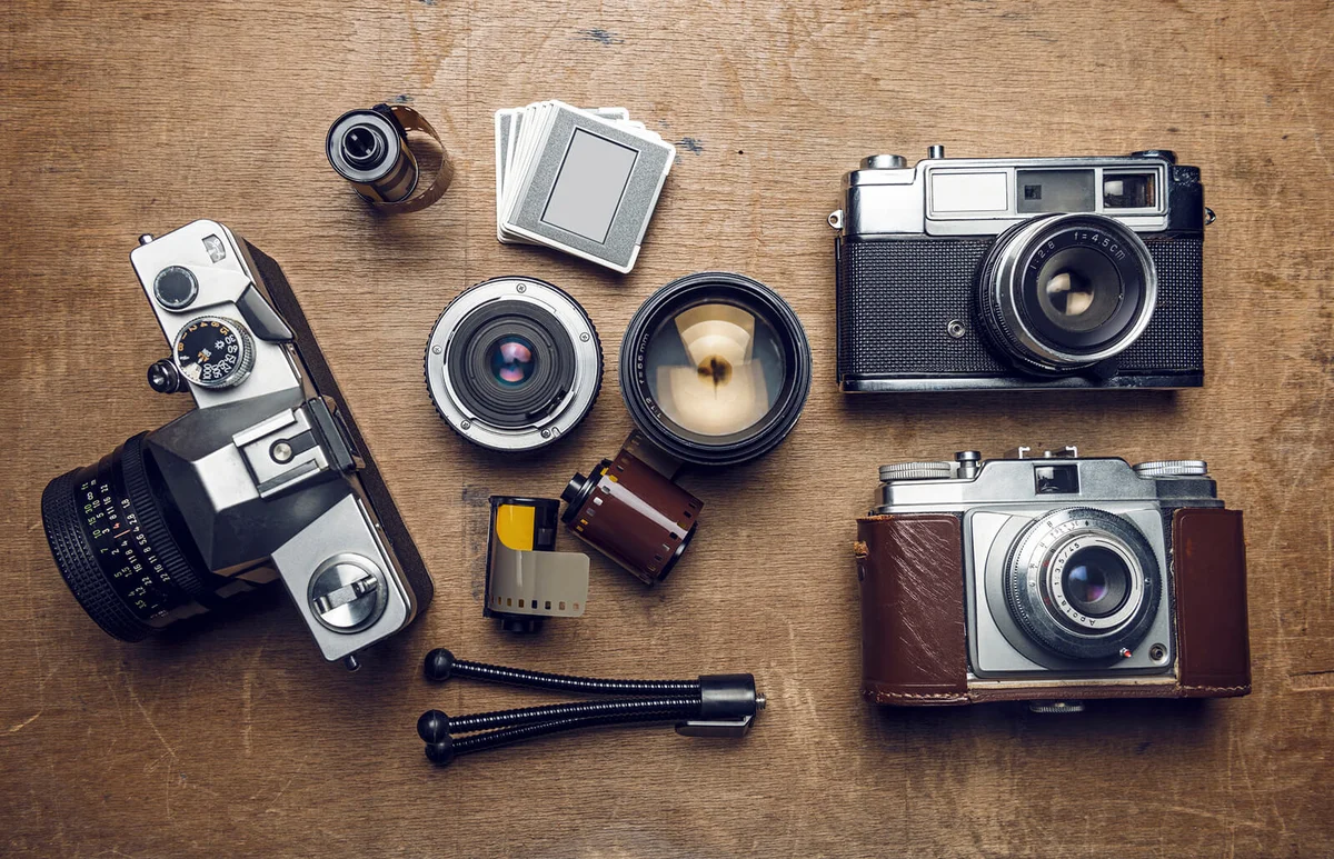 Vintage cameras and photography equipment on wood
