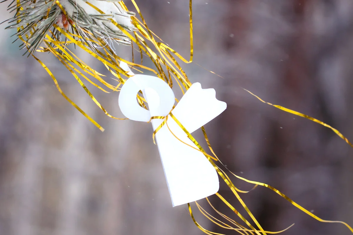 Paper angel and glossy golden ribbon
