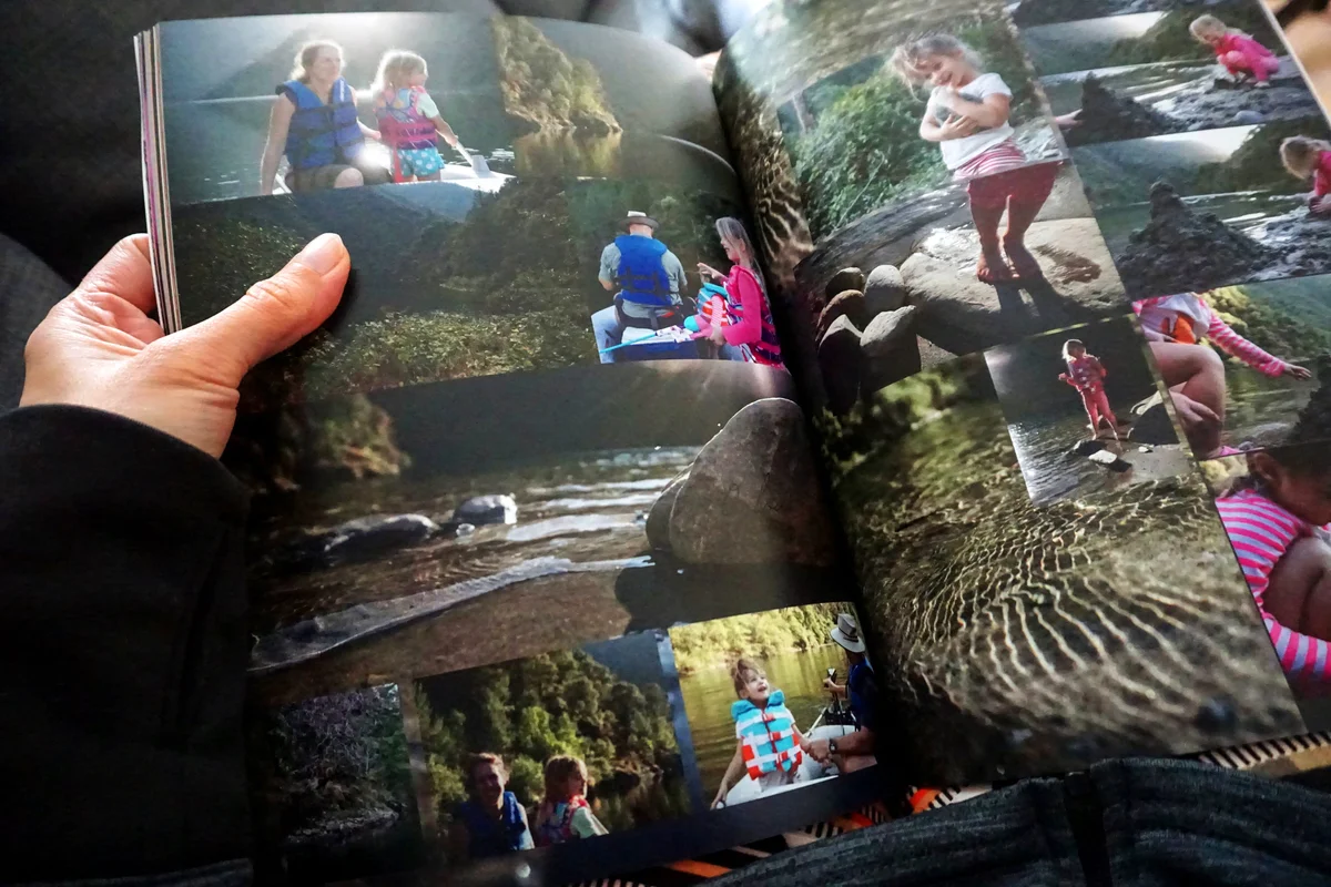 Person holding a photo album created and printed