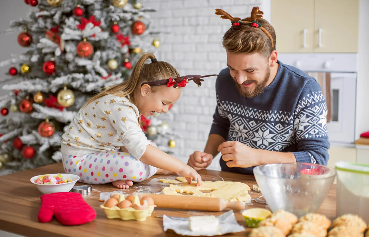 Father and daughter baking cookies for Christmas