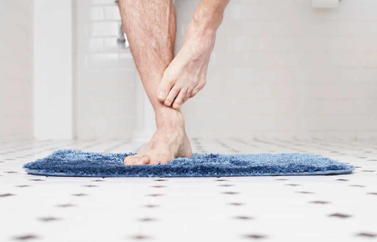 Man standing on bathmat