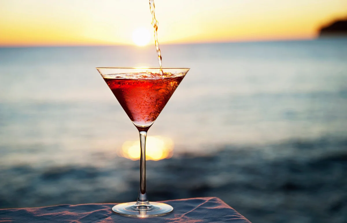 Cocktail pouring in glass outdoors