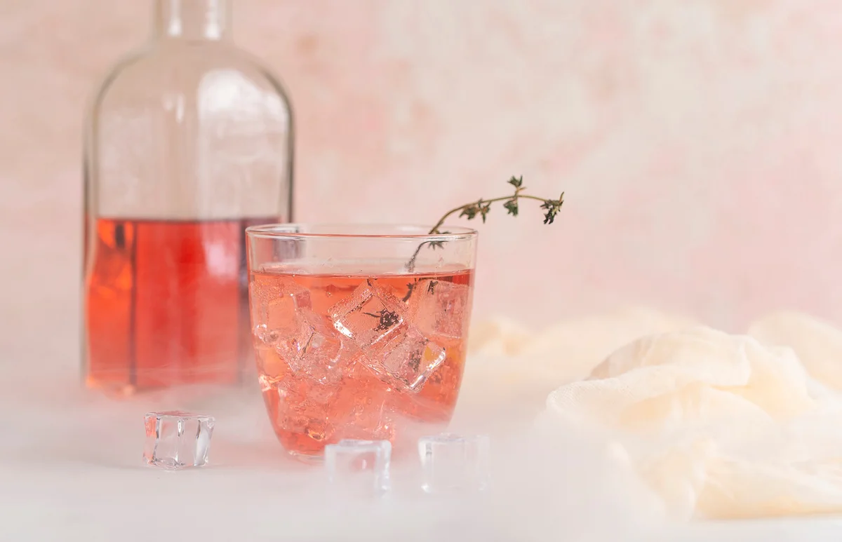 Pink cocktail with ice cubes
