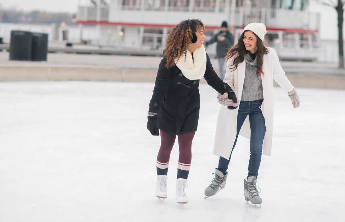 Adult female couple ice skating