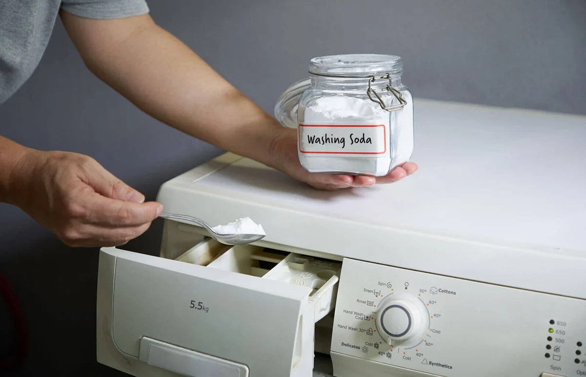man adding baking soda into washing machine