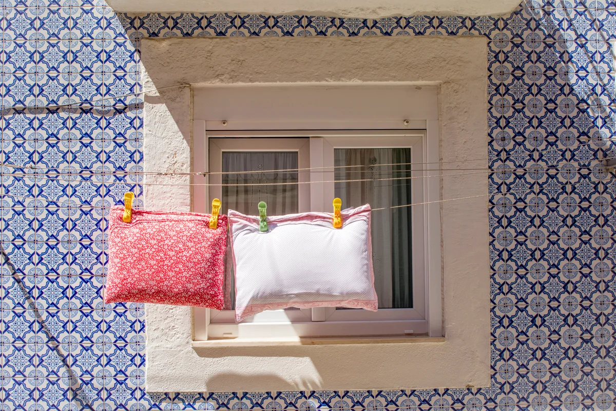 Throw pillows drying on a rope