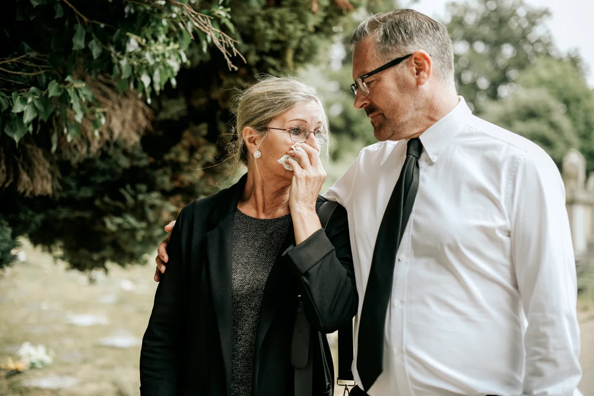 Husband trying to comfort his wife due to her loss